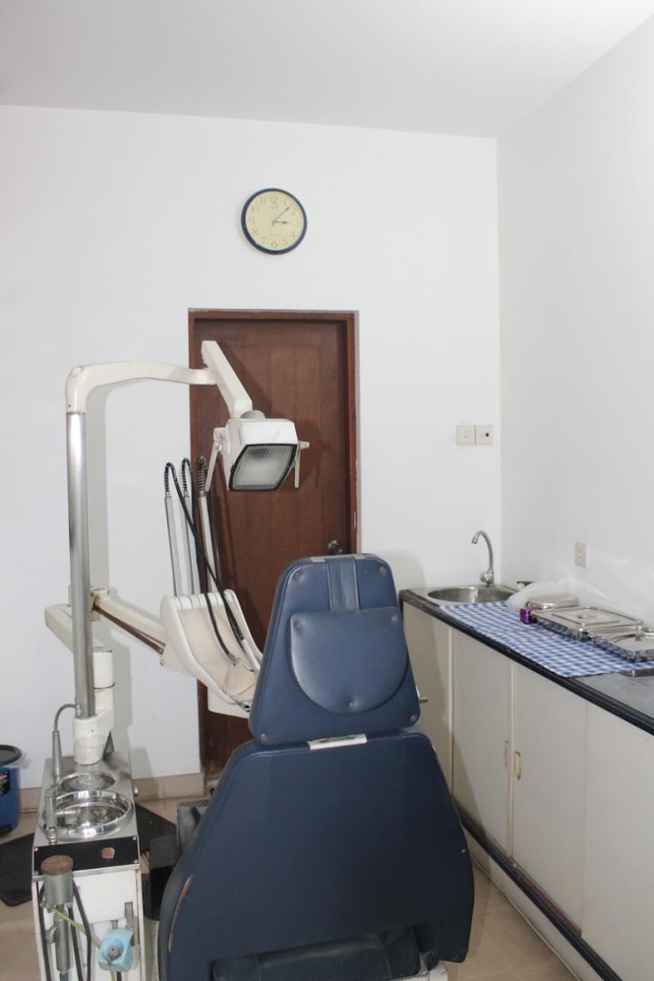 Dental chair, lamp, sink, and instrument counter