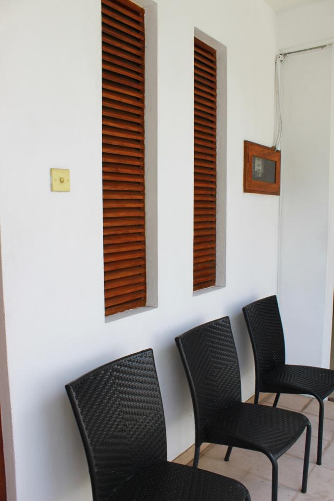 Waiting chairs beside warm wood ventilation panels